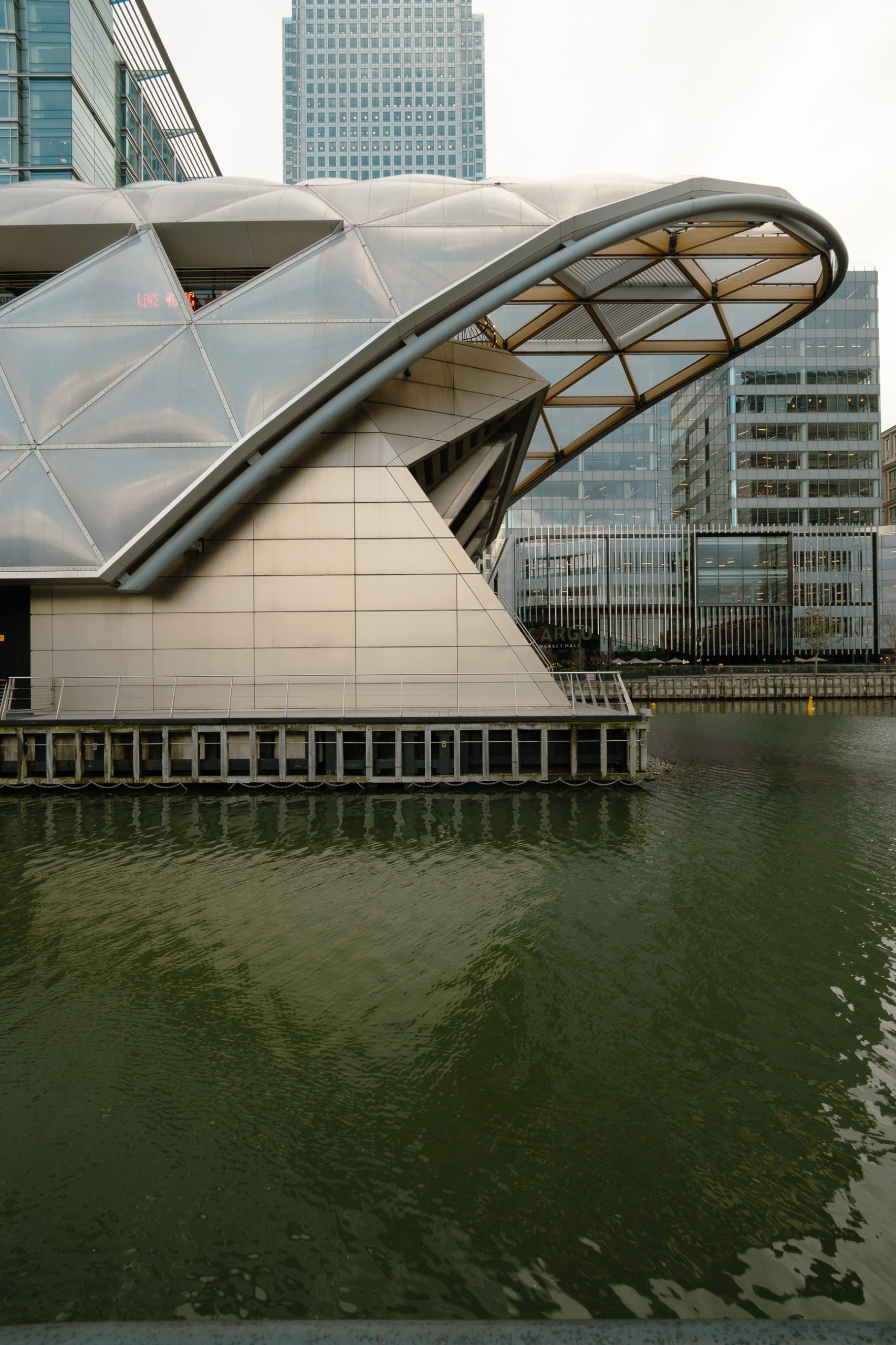 The Eastern end of the Elizabeth Line's Canary Wharf station viewed in profile. It resembles the prow of a large ship.