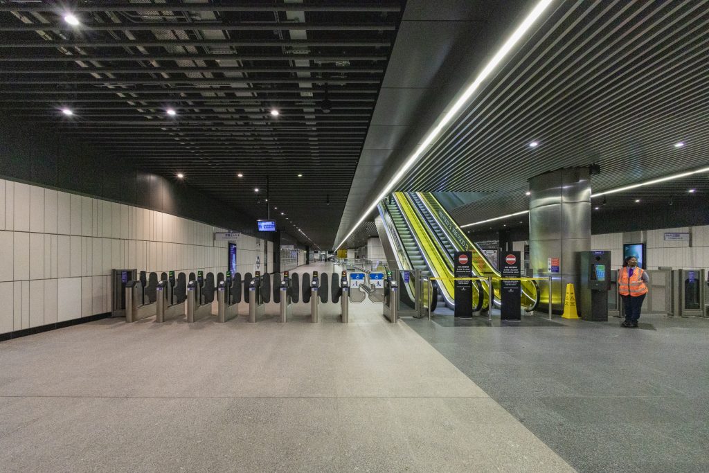 A longditudinal view of the largely empty Elizabeth Line ticket hall at Canary Wharf statsion