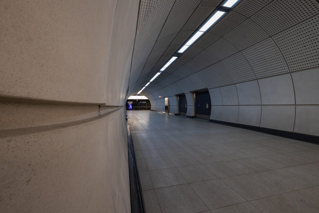A picture taken close to the wall at the corner of the access and connecting tunnel corridors using the detailing of the walls as leading lines