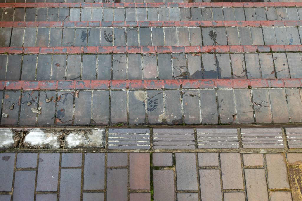 Broken and cracked tiles form part of descending steps