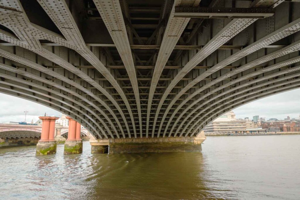Steel beams arch across the Thames in London. They reach for the other side. A step on a much longer journey